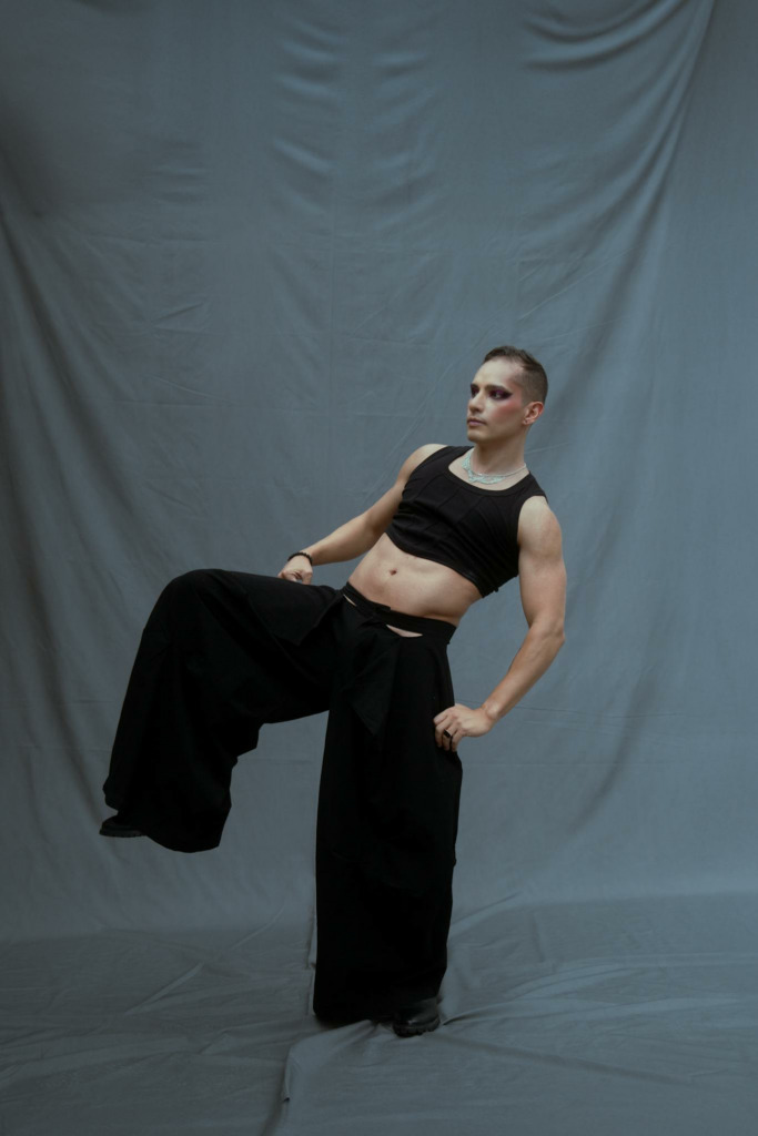 Stylish model posing in contemporary fashion in a studio setting.